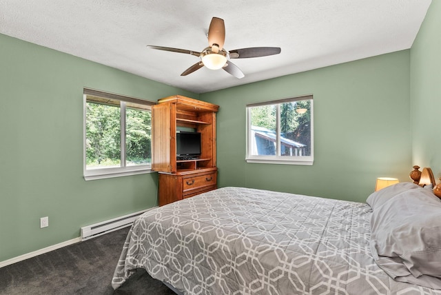 161 S Alaska Ln, Cusick, WA 99119 - bedroom with a baseboard heating unit, carpet floors, and a ceiling fan