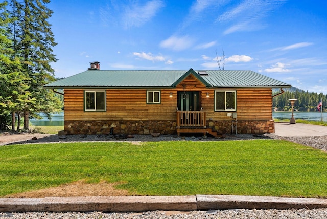 161 S Alaska Ln, Cusick, WA 99119 - rustic home featuring a front lawn, a metal roof, a water view, and a chimney