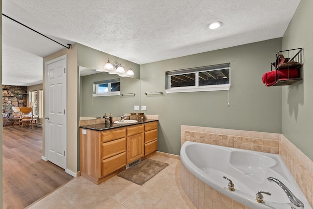 161 S Alaska Ln, Cusick, WA 99119 - full bathroom with vanity, a bath, and a textured ceiling