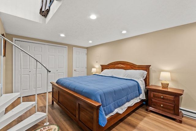 161 S Alaska Ln, Cusick, WA 99119 - bedroom with wood finished floors, a closet, recessed lighting, and baseboard heating