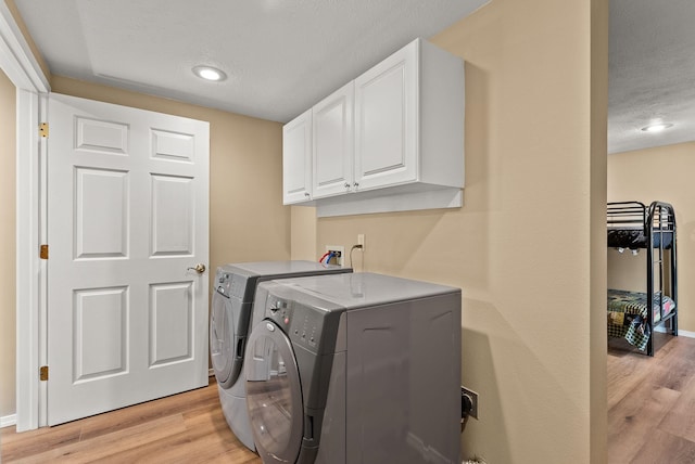 161 S Alaska Ln, Cusick, WA 99119 - laundry area with cabinet space, washer and clothes dryer, light wood-style flooring, a textured ceiling, and recessed lighting