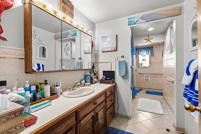 4821 S Conklin Rd, Greenacres, WA 99016 - bathroom with tile walls, tile patterned floors, vanity, curtained shower, and wainscoting