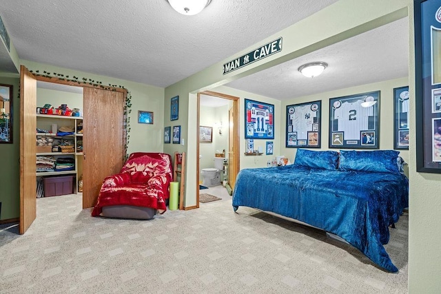 4821 S Conklin Rd, Greenacres, WA 99016 - bedroom with a textured ceiling, carpet, and ensuite bath
