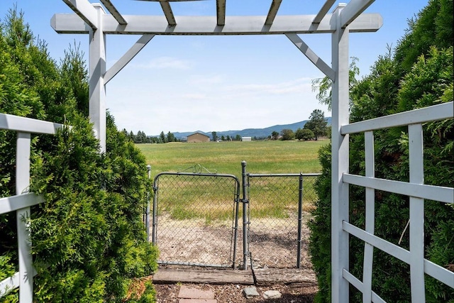 4821 S Conklin Rd, Greenacres, WA 99016 - view of yard with a gate, a mountain view, a pergola, and a rural view
