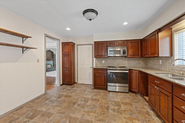 1007 W 15th Ave, Spokane, WA 99203 - kitchen featuring stainless steel appliances, tasteful backsplash, stone finish flooring, open shelves, and recessed lighting