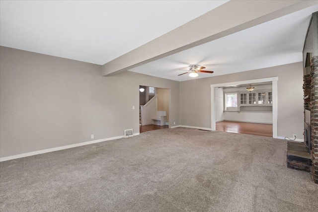 1007 W 15th Ave, Spokane, WA 99203 - unfurnished living room with carpet floors, a ceiling fan, stairs, and beam ceiling