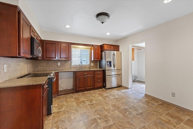 1007 W 15th Ave, Spokane, WA 99203 - kitchen with appliances with stainless steel finishes, backsplash, recessed lighting, stone finish floors, and light stone counters