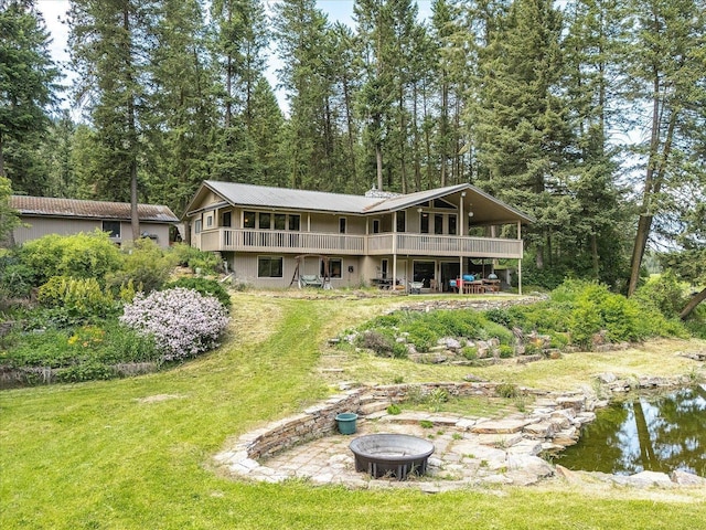 512 Williams Lake Rd, Colville, WA 99114 - rear view of property with a fire pit, a wooden deck, and a yard