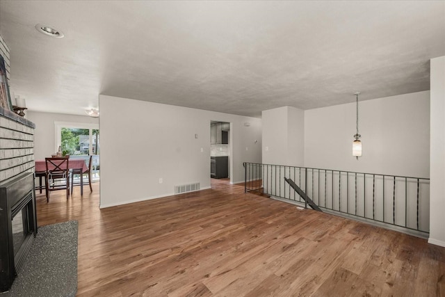 426 E 17th St, Spokane, WA 99203 - unfurnished room featuring wood finished floors and a glass covered fireplace