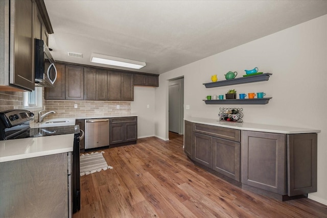 426 E 17th St, Spokane, WA 99203 - kitchen with appliances with stainless steel finishes, backsplash, dark wood finished floors, dark brown cabinetry, and open shelves