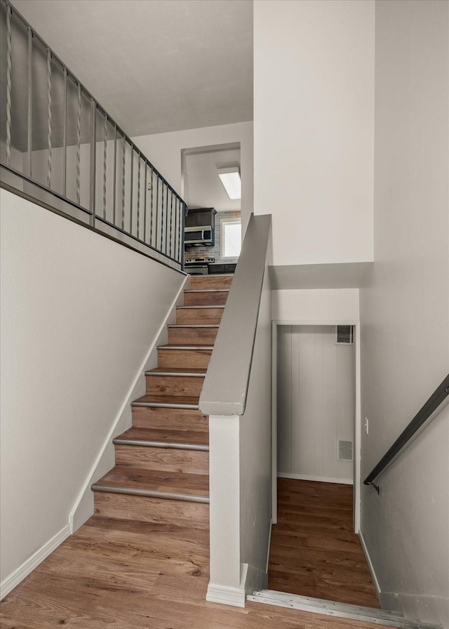 426 E 17th St, Spokane, WA 99203 - stairway with wood finished floors and baseboards
