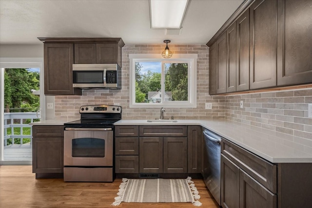 426 E 17th St, Spokane, WA 99203 - kitchen featuring stainless steel appliances, backsplash, and light countertops