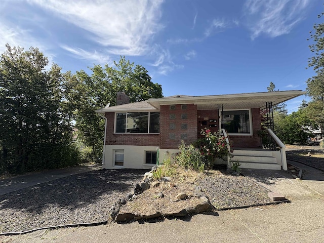 820/828 W 11th Ave, Spokane, WA 99204 - view of front facade featuring brick siding, a porch, and a chimney