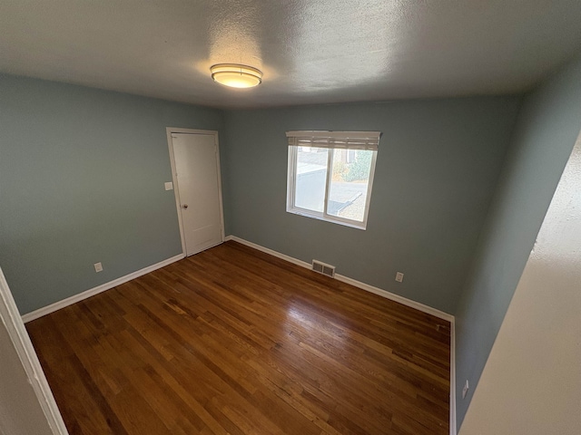 820/828 W 11th Ave, Spokane, WA 99204 - unfurnished room featuring dark wood finished floors and a textured ceiling