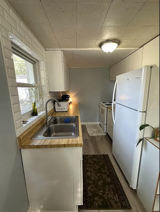 820/828 W 11th Ave, Spokane, WA 99204 - kitchen featuring white appliances, dark wood-style floors, white cabinets, and decorative backsplash