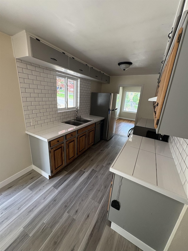 820/828 W 11th Ave, Spokane, WA 99204 - kitchen featuring stainless steel appliances, backsplash, and light wood-type flooring