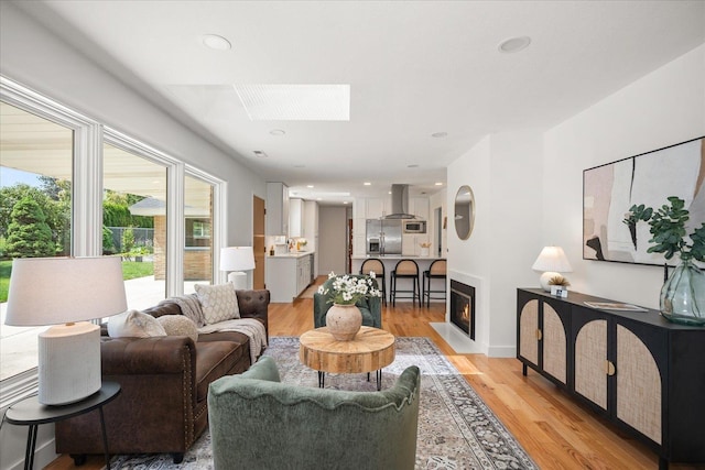 915 W 32nd Ave, Spokane, WA 99203 - living room featuring a skylight, light wood finished floors, a fireplace with flush hearth, and recessed lighting
