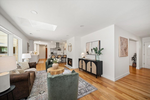 915 W 32nd Ave, Spokane, WA 99203 - living area with a skylight, light wood-type flooring, and a fireplace with flush hearth