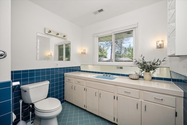 915 W 32nd Ave, Spokane, WA 99203 - bathroom with tile patterned flooring, vanity, tile walls, and wainscoting