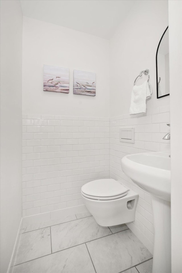 915 W 32nd Ave, Spokane, WA 99203 - half bath featuring marble look tile flooring and tile walls