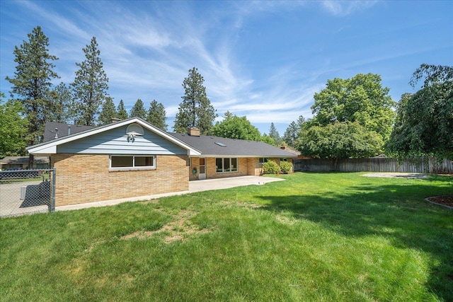 915 W 32nd Ave, Spokane, WA 99203 - rear view of property with a patio, a fenced backyard, and a chimney