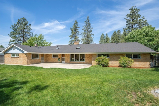 915 W 32nd Ave, Spokane, WA 99203 - back of property with a patio, a chimney, and brick siding