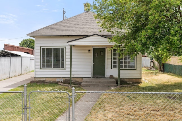 405 W 5th St, Sprague, WA 99204 - view of front facade with a gate, roof with shingles, and a fenced backyard