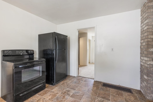 405 W 5th St, Sprague, WA 99204 - kitchen featuring black appliances and stone finish flooring