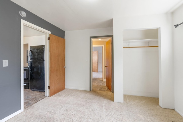 405 W 5th St, Sprague, WA 99204 - unfurnished bedroom with freestanding refrigerator, a closet, and carpet floors