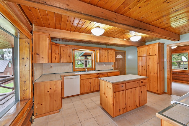42325 N Sylvan Rd, Elk, WA 99009 - kitchen featuring tile countertops, white dishwasher, decorative backsplash, a center island, and a wooden ceiling with exposed beams