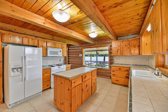 42325 N Sylvan Rd, Elk, WA 99009 - kitchen featuring white appliances, tile countertops, a center island, log walls, and backsplash