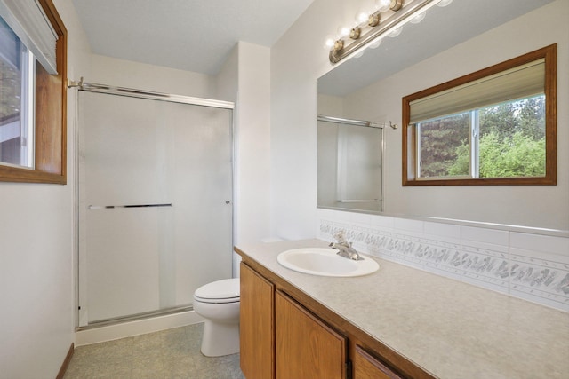 15618 N Chronicle Ct, Mead, WA 99021 - bathroom featuring vanity, a stall shower, and backsplash