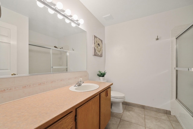 15618 N Chronicle Ct, Mead, WA 99021 - bathroom featuring vanity, tile patterned flooring, combined bath / shower with glass door, and backsplash