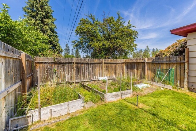 1003 W Eastmont Way, Spokane, WA 99208 - fenced backyard with a vegetable garden