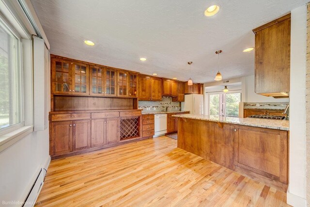 1003 W Eastmont Way, Spokane, WA 99208 - kitchen with white appliances, brown cabinets, light wood finished floors, a peninsula, and recessed lighting