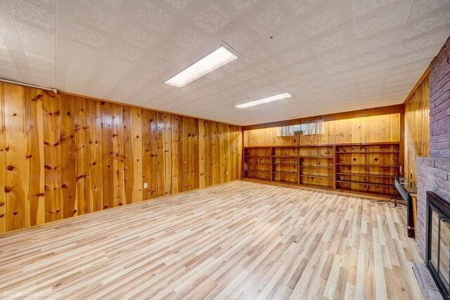 1003 W Eastmont Way, Spokane, WA 99208 - unfurnished living room featuring wood walls and wood finished floors