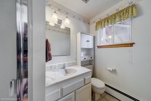 1003 W Eastmont Way, Spokane, WA 99208 - half bath with a baseboard heating unit, vanity, and tile patterned floors