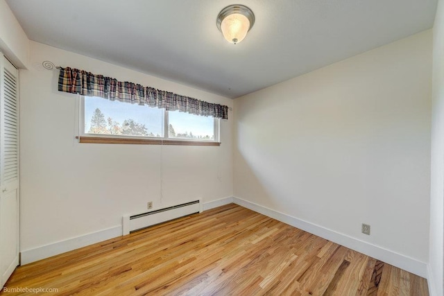 1003 W Eastmont Way, Spokane, WA 99208 - unfurnished bedroom featuring a baseboard heating unit and light wood-type flooring