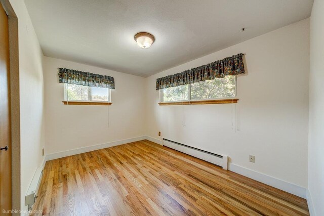 1003 W Eastmont Way, Spokane, WA 99208 - unfurnished room with a baseboard heating unit and light wood-style flooring