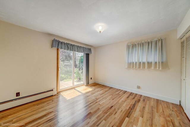 1003 W Eastmont Way, Spokane, WA 99208 - unfurnished room featuring a baseboard heating unit and wood finished floors