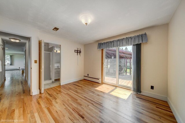 1003 W Eastmont Way, Spokane, WA 99208 - spare room featuring baseboard heating, light wood-style floors, and a baseboard heating unit