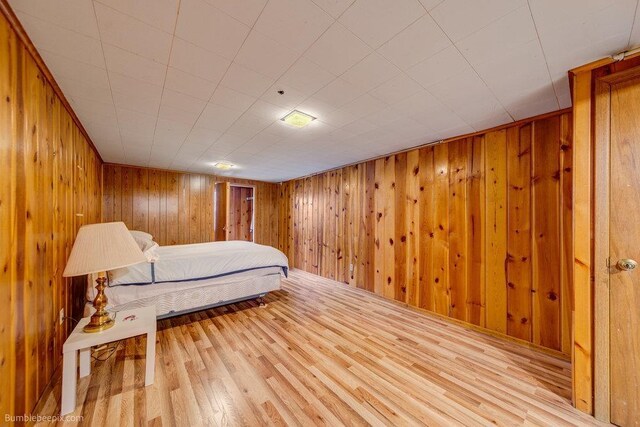 1003 W Eastmont Way, Spokane, WA 99208 - bedroom featuring wood finished floors and wooden walls