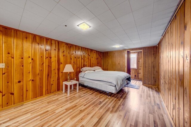 1003 W Eastmont Way, Spokane, WA 99208 - bedroom with light wood-style flooring and wood walls