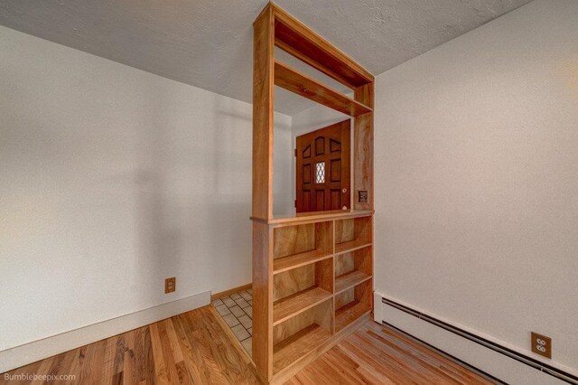 1003 W Eastmont Way, Spokane, WA 99208 - unfurnished room with a baseboard radiator and wood finished floors