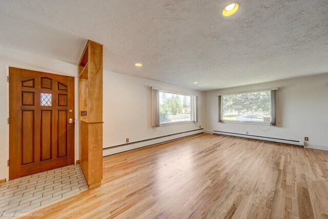 1003 W Eastmont Way, Spokane, WA 99208 - foyer entrance featuring a baseboard radiator, baseboard heating, wood finished floors, a textured ceiling, and recessed lighting