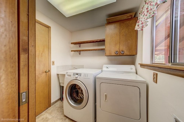 1003 W Eastmont Way, Spokane, WA 99208 - washroom featuring cabinet space, washing machine and clothes dryer, and light tile patterned flooring
