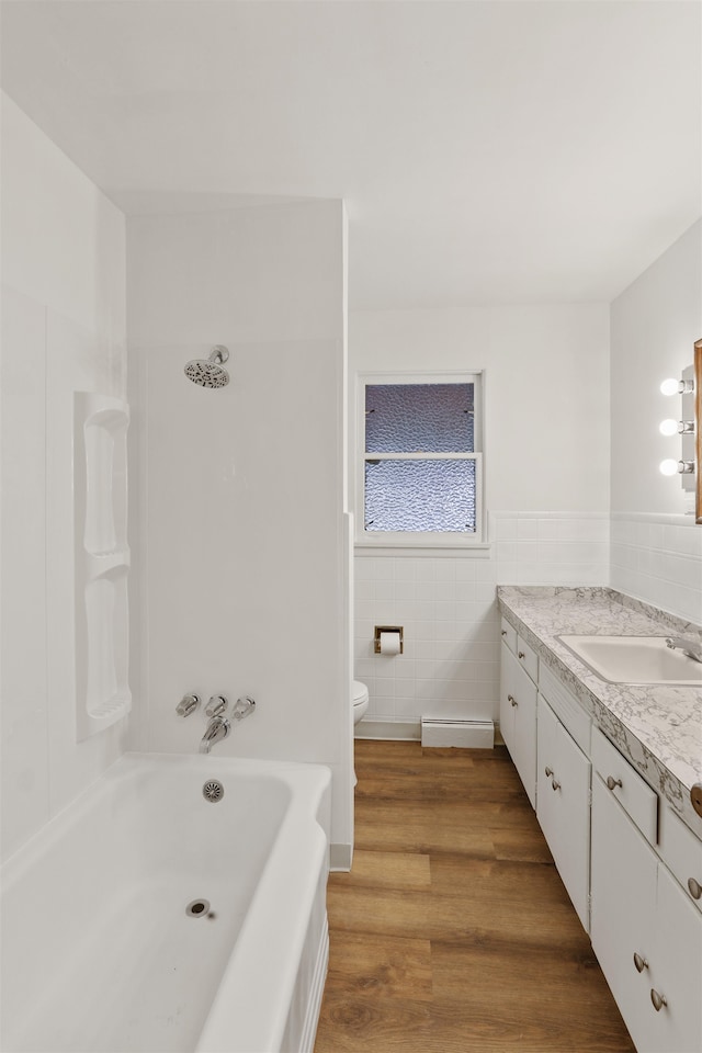 5804 N Maple St, Spokane, WA 99205 - full bathroom with tile walls, vanity, wood finished floors, shower / bathtub combination, and a wainscoted wall
