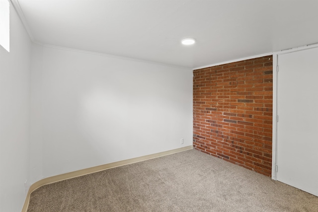 5804 N Maple St, Spokane, WA 99205 - empty room featuring brick wall, carpet flooring, and ornamental molding