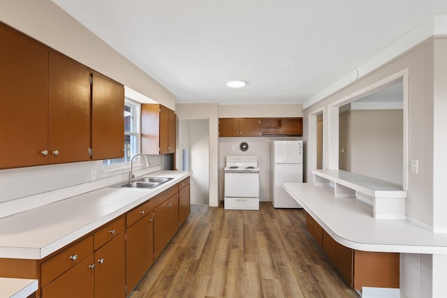 5804 N Maple St, Spokane, WA 99205 - kitchen with white appliances, light countertops, dark wood-type flooring, and brown cabinetry