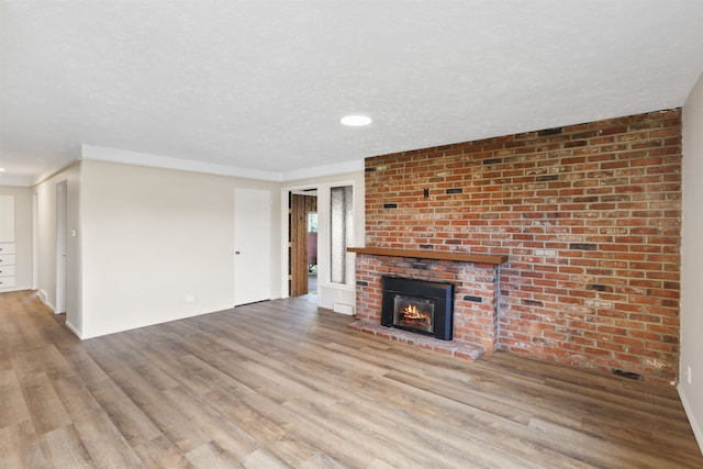5804 N Maple St, Spokane, WA 99205 - unfurnished living room with wood finished floors, a brick fireplace, and recessed lighting